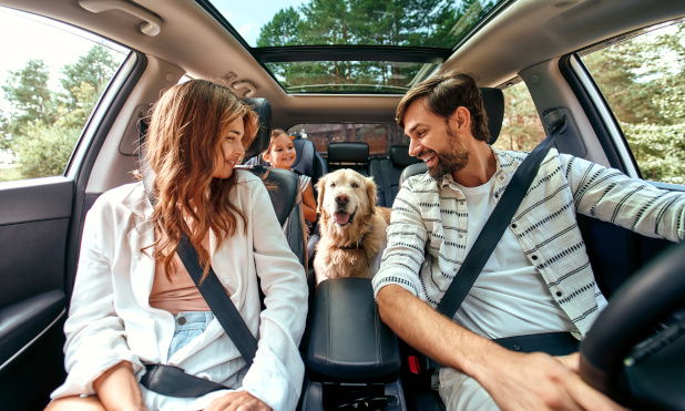 Parents, child, and dog riding together with Onust extended auto protection